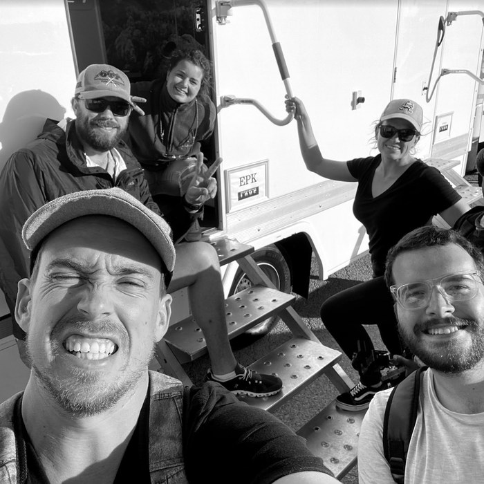 The crew by the EPK trailer on set